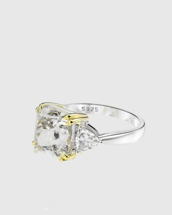 Close-up side profile of the Aerion Imperia ring revealing the sophisticated two-tone setting with 18K yellow gold prongs holding the spectacular 10x10mm icy white center stone.