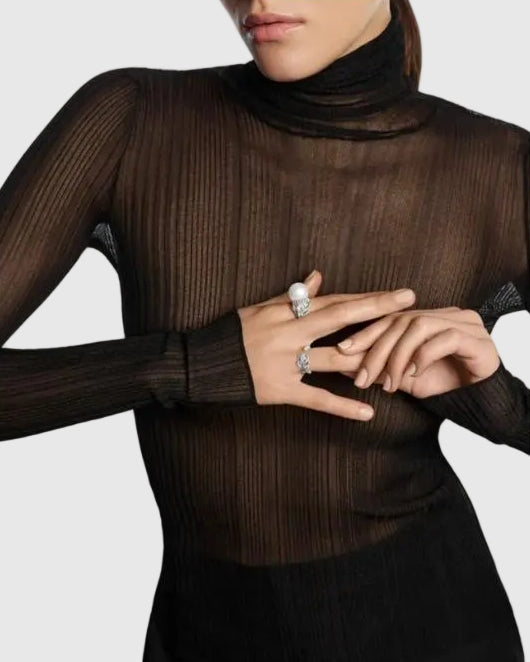 A luxury editorial photo of a model wearing the L’Éthérée peacock feather matching diamond rings, showcasing a quiet luxury aesthetic.