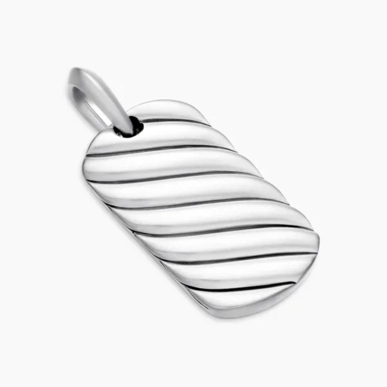 Angled view of a sterling silver pendant with diagonal cable-inspired grooves and a polished bail.