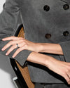 a person wearing a VELTORI BAND RING WITH BEES AND GG.
