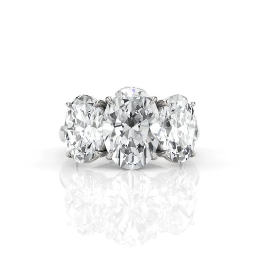Diamond ring with three large diamonds on a white background