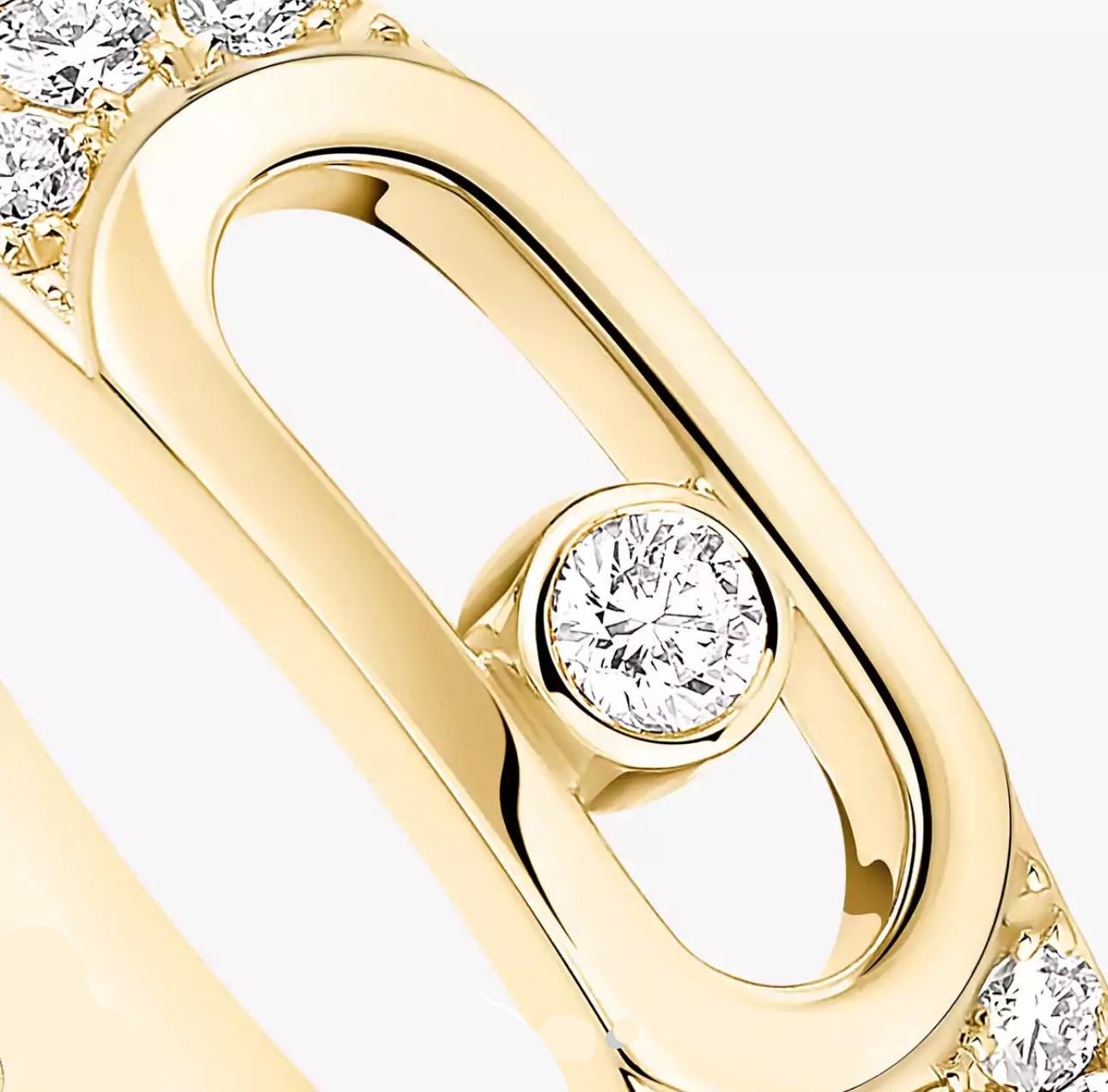 Gold ring with diamond accents on a light gray background