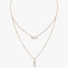 Rose gold necklace with bar pendants on a white background