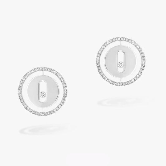 Pair of silver earrings with circular design on a white background