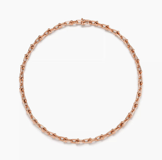 Rose Gold chain Horsebit link design necklace on a white background