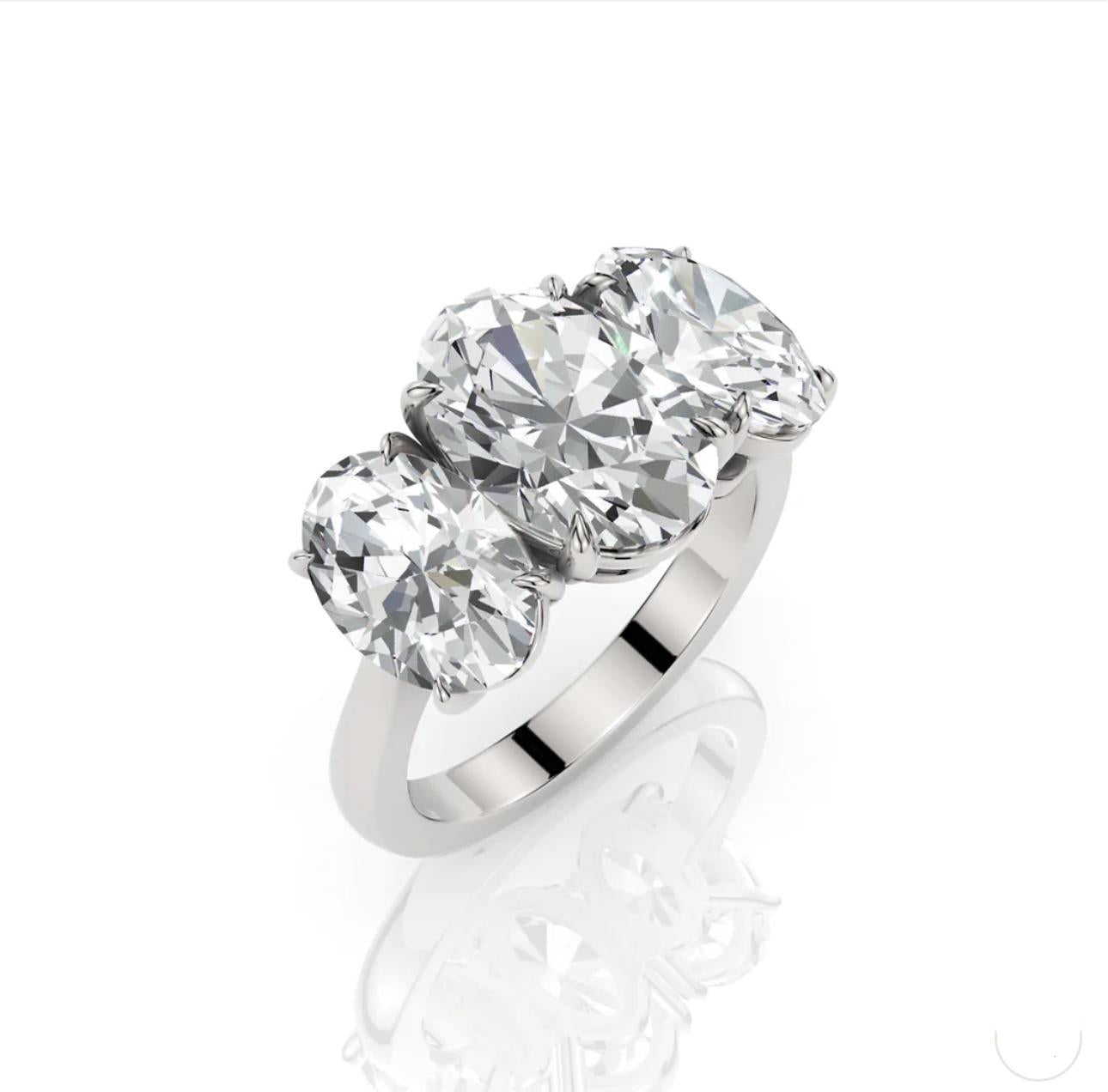 Silver ring with three large diamonds on a white background