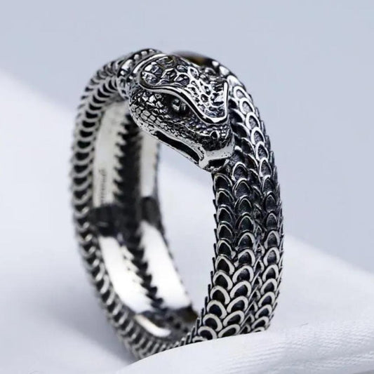 Silver snake-shaped ring on a white background