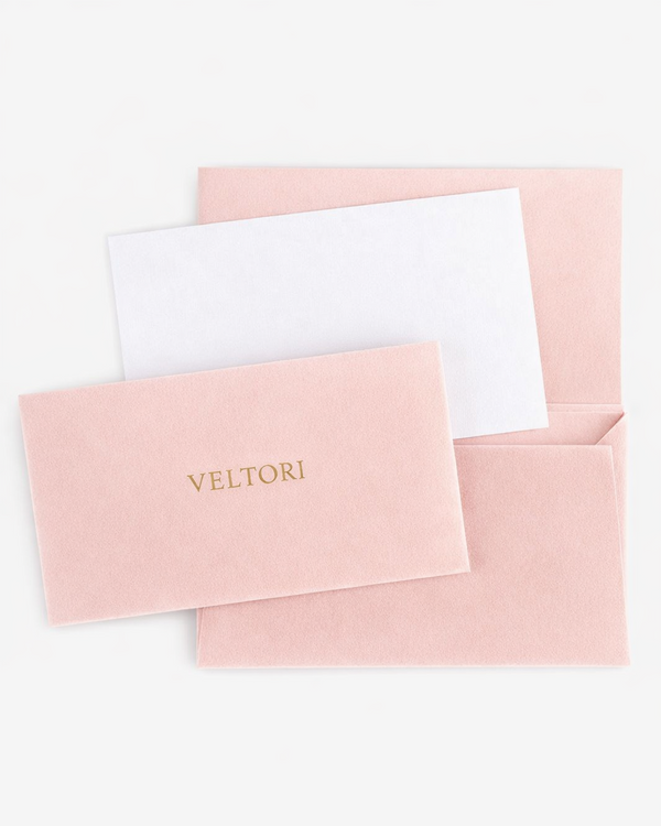 VELTORI luxury velvet envelopes in blush pink gradient with gold logo, elegant fashion brand stationery