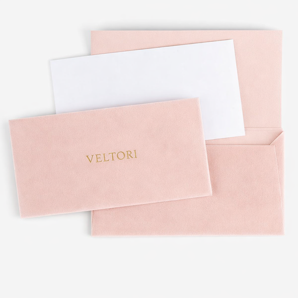 VELTORI luxury packaging – blush pink velvet envelope with champagne gold logo