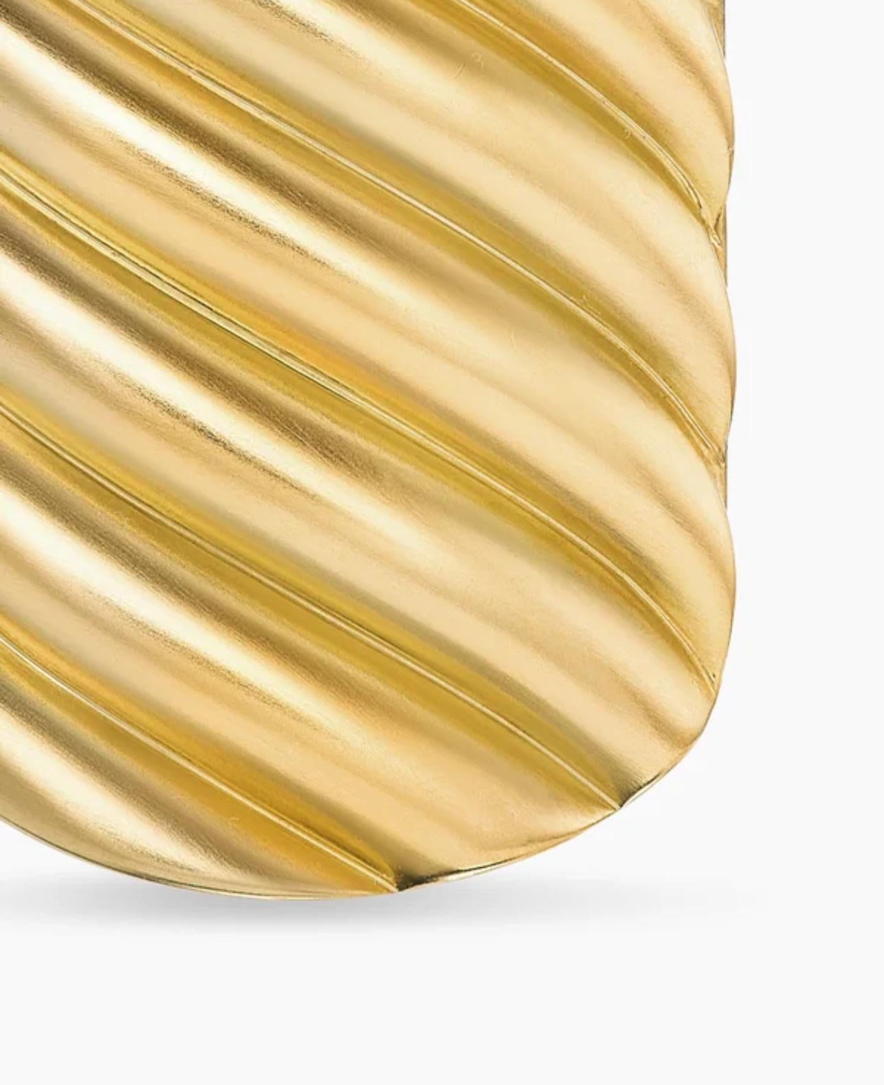 Close-up of the sterling silver tag pendant showing diagonal twisted grooves with a polished curved edge.