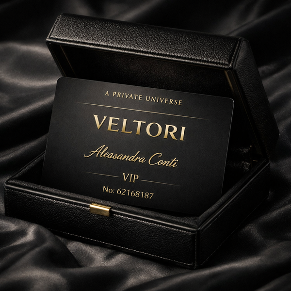 Matte black VELTORI VIP metal membership card with gold lettering, partially revealed from a luxury leather box, symbolizing exclusive privilege and authority