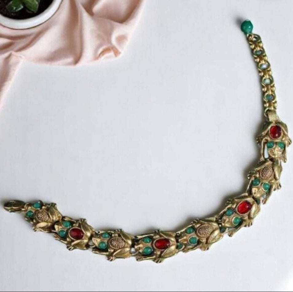 Decorative necklace with gemstones on a white surface