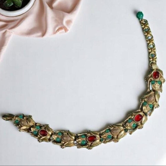 Decorative necklace with gemstones on a white surface