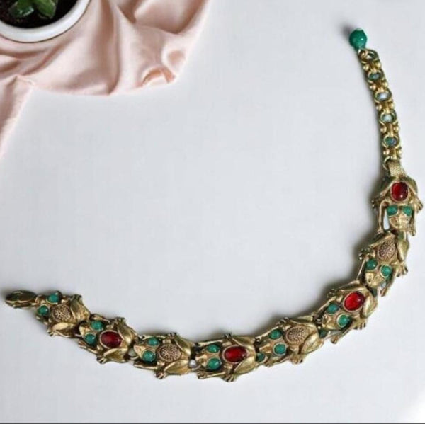 Decorative necklace with gemstones on a white surface