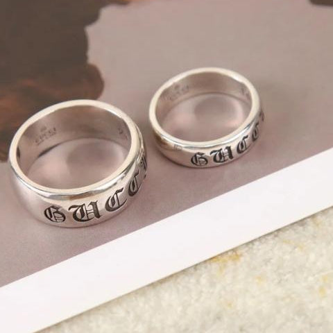 Two silver rings with engraved text on a light background