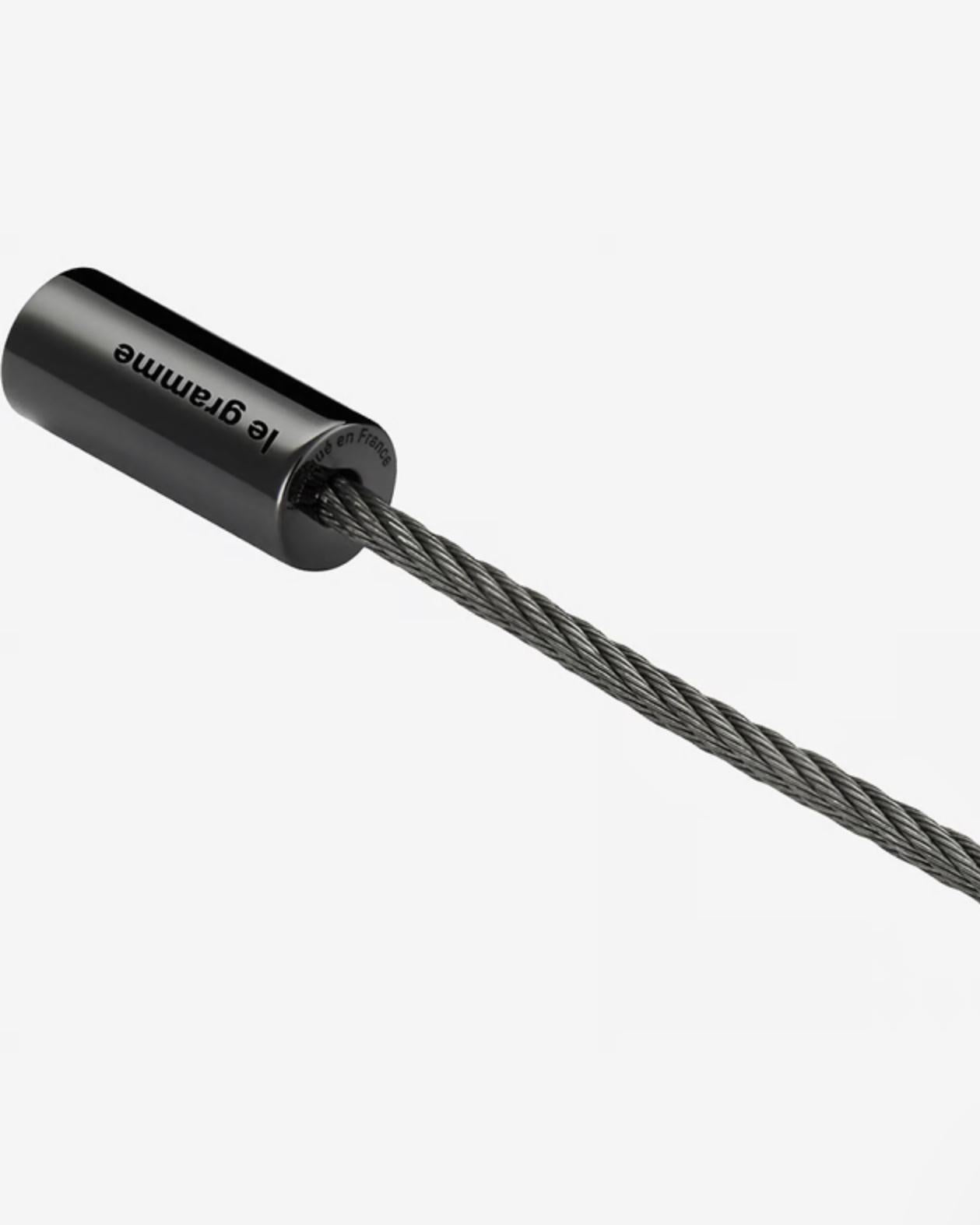 Close-up of a black cable end with 'le Gramme' branding on a white background