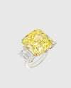 Angled studio shot of the Aerion Soleil high-jewelry ring featuring a giant square fancy yellow crushed ice center stone flanked by trillion-cut white side stones.