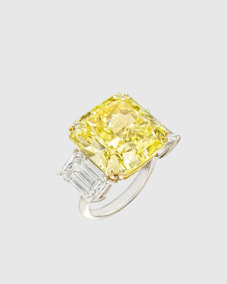 Angled studio shot of the Aerion Soleil high-jewelry ring featuring a giant square fancy yellow crushed ice center stone flanked by trillion-cut white side stones.