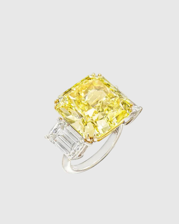 Angled studio shot of the Aerion Soleil high-jewelry ring featuring a giant square fancy yellow crushed ice center stone flanked by trillion-cut white side stones.