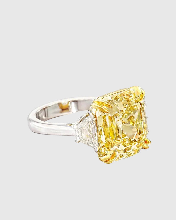 Angled studio shot of the Aerion Soleil high-jewelry ring featuring a giant square fancy yellow crushed ice center stone flanked by trillion-cut white side stones.