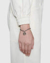 Lifestyle shot of a model wearing the Aerion Marmont 925 silver chunky chain bracelet with an oxidized monogram pendant on the wrist.