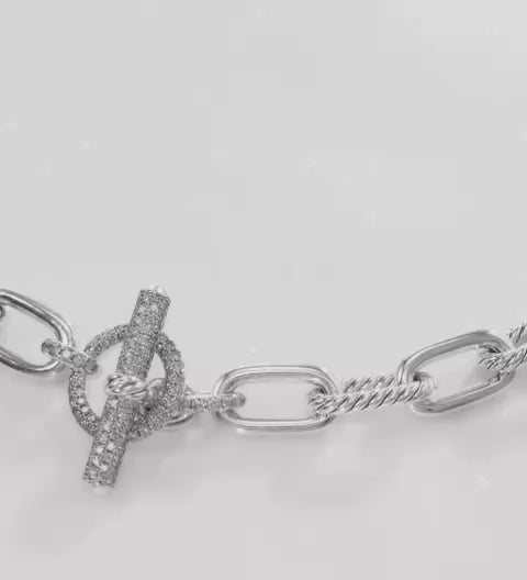 Close up Silver chain bracelet with a Pave Toggle clasp on a white background