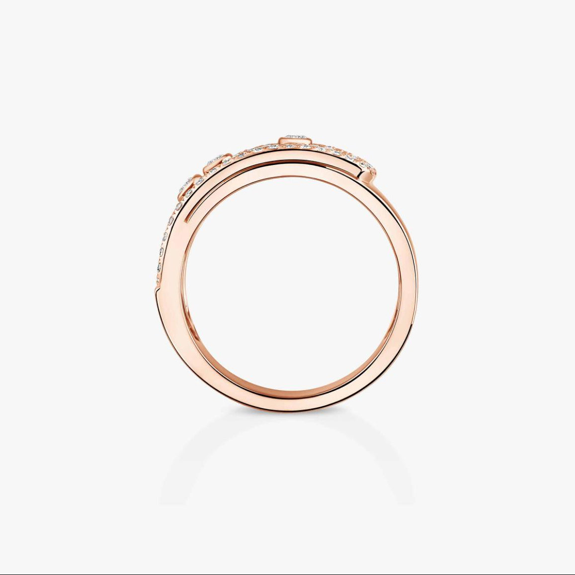 Rose gold ring with small diamonds on a light gray background