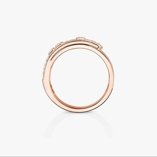 Rose gold ring with small diamonds on a light gray background