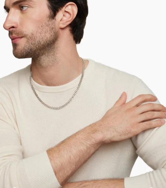 Man wearing a beige sweater with a neutral background