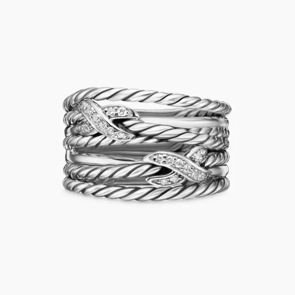 Stack of silver rings with diamond accents on a white background