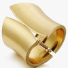 Gold cuff bracelet on a white background