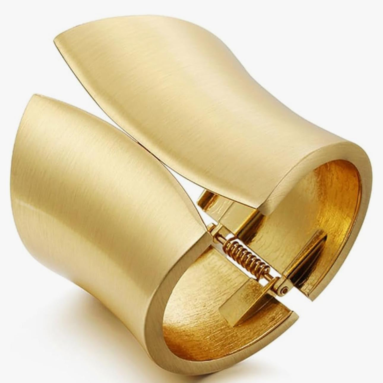 Gold cuff bracelet on a white background