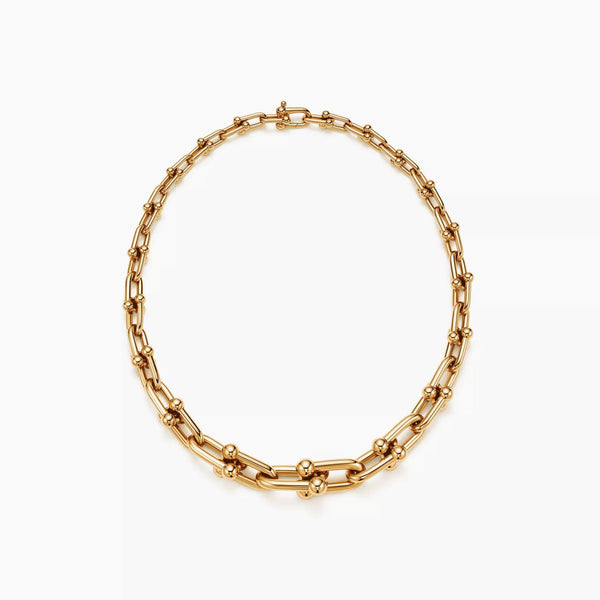Gold chain necklace on a white background