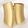 Gold cuff bracelet on a white background