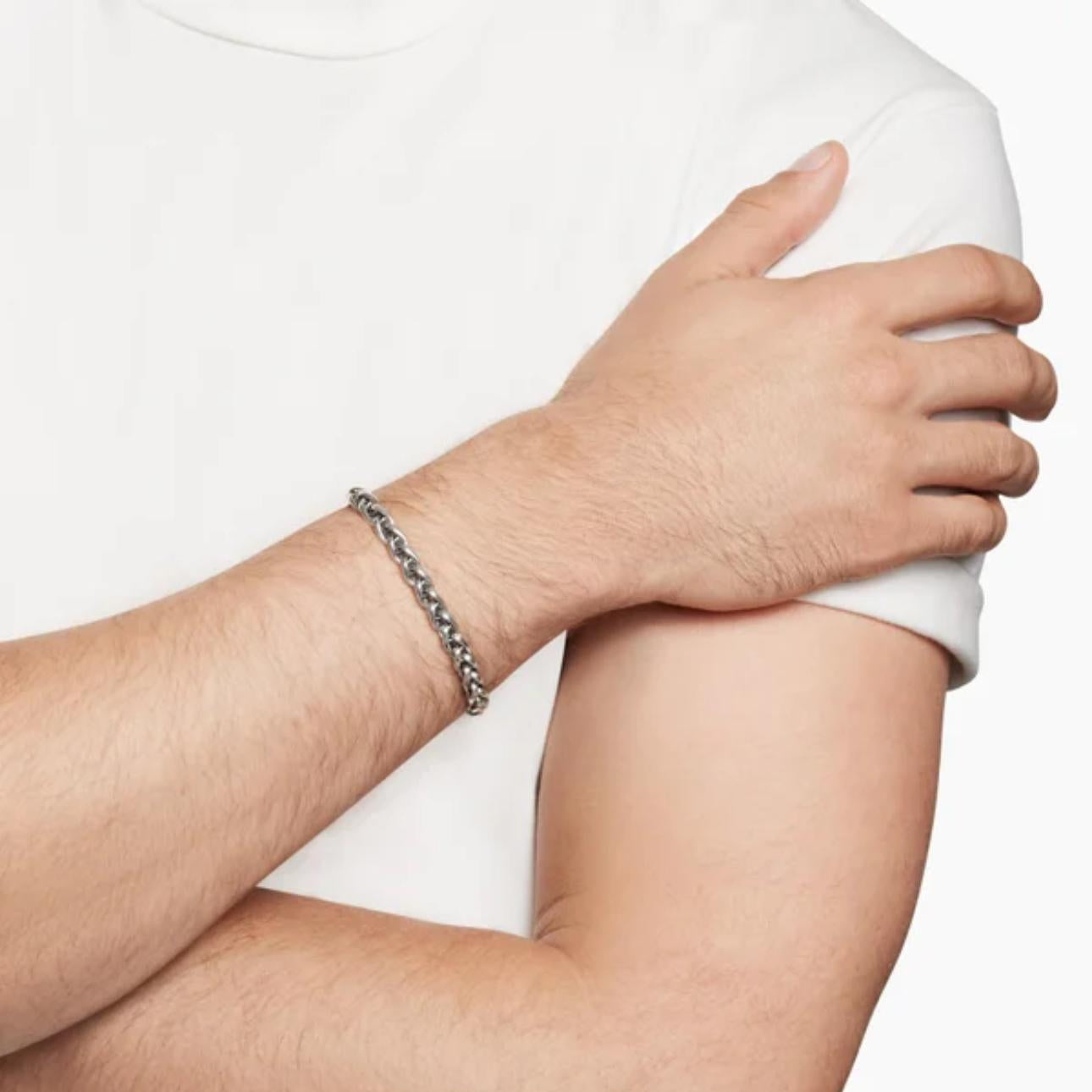 Person wearing a bracelet on a white background