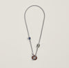 Necklace with a pendant on a light gray background