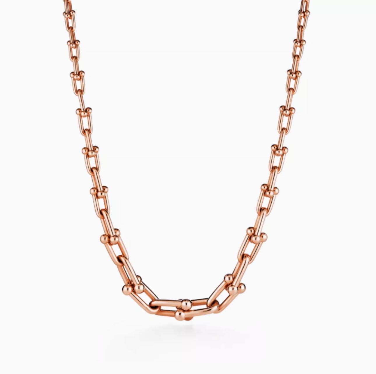 Rose gold chain necklace on a white background