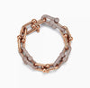 Rose gold bracelet with interlocking links on a white background
