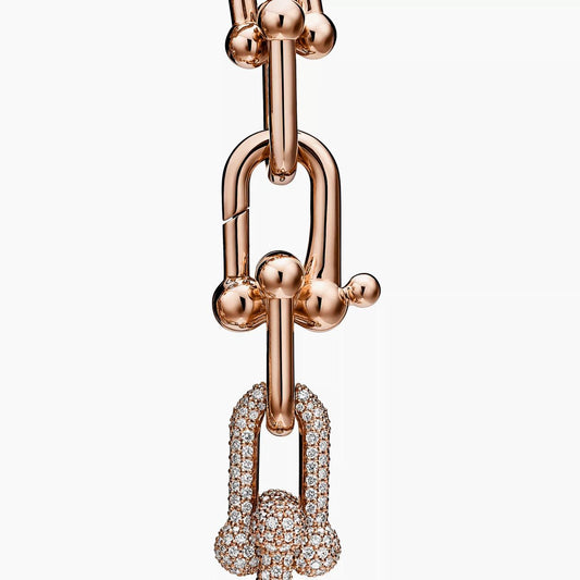 Rose gold necklace with diamond pendants on a white background