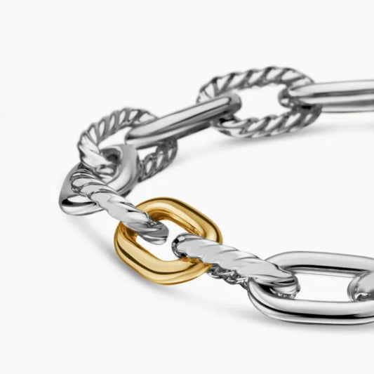 Silver and gold chain bracelet on a white background