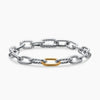 Silver chain bracelet with a gold ring on a white background