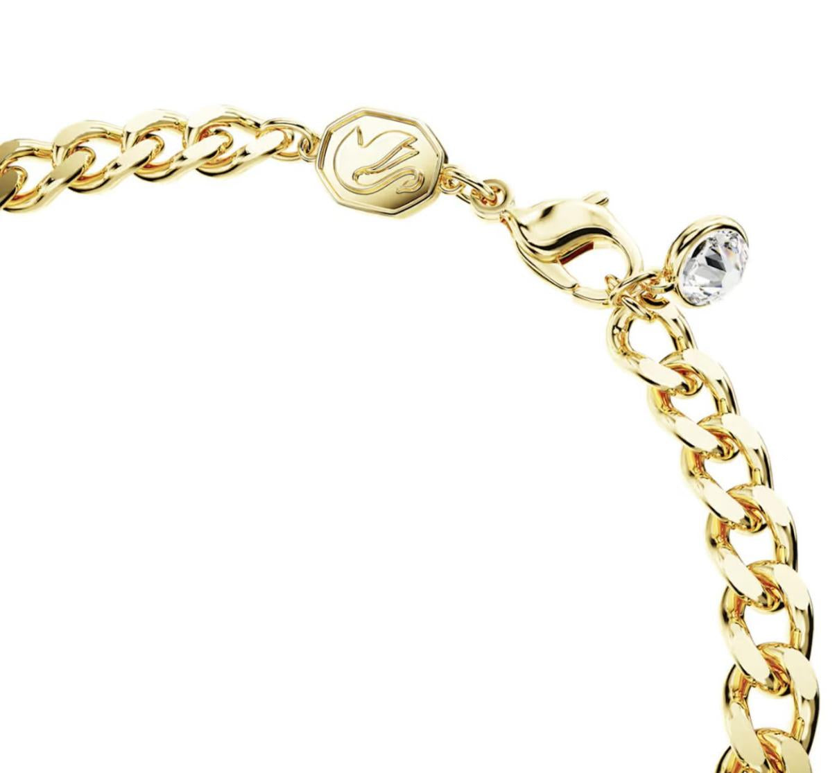 Gold chain bracelet with a clasp and clear gemstone on a white background