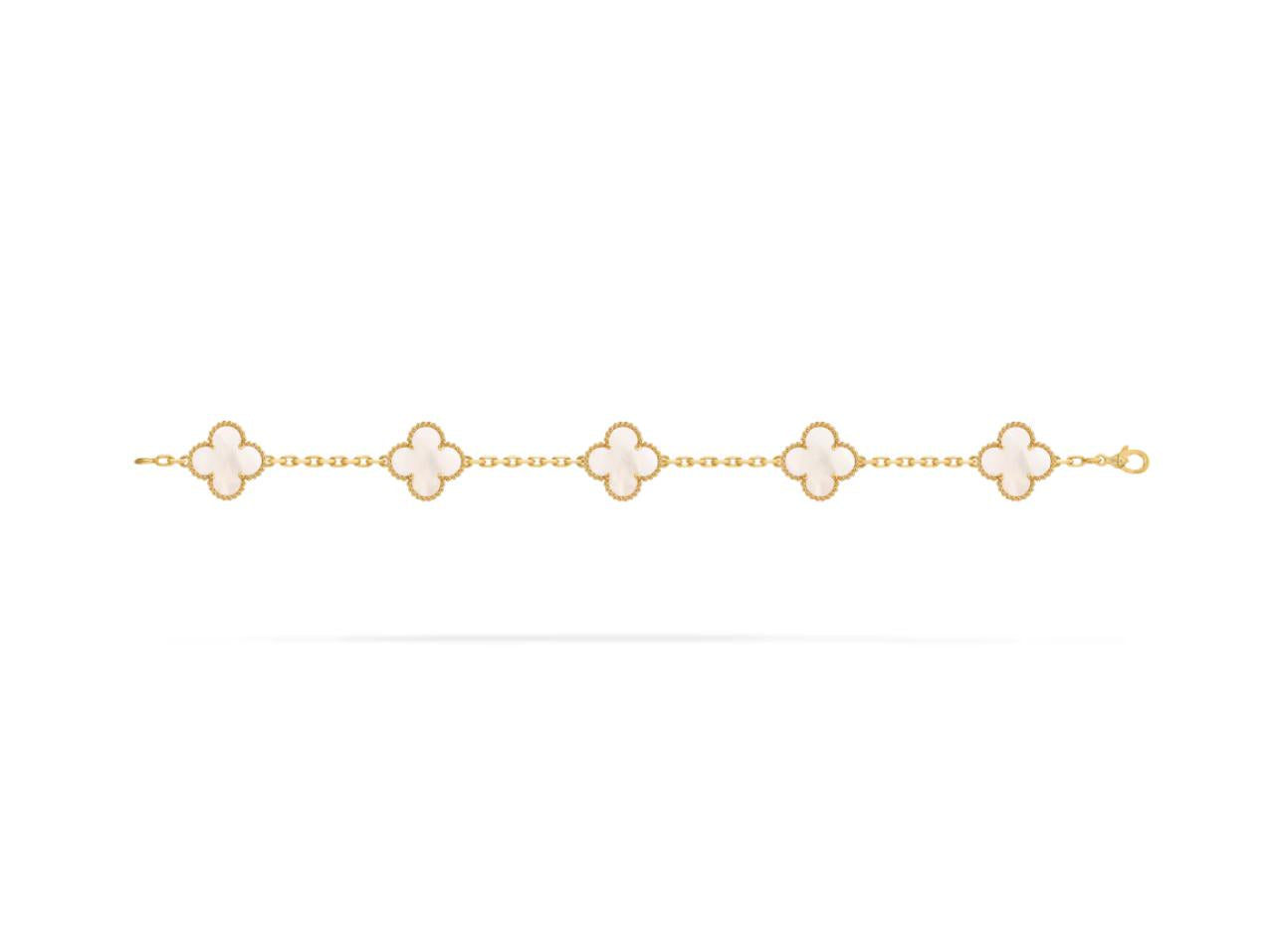 Gold bracelet with four-leaf clover charms on a white background