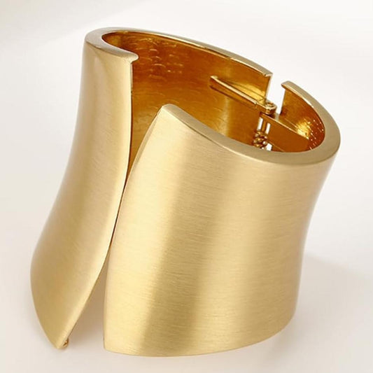 Gold cuff bracelet on a white background