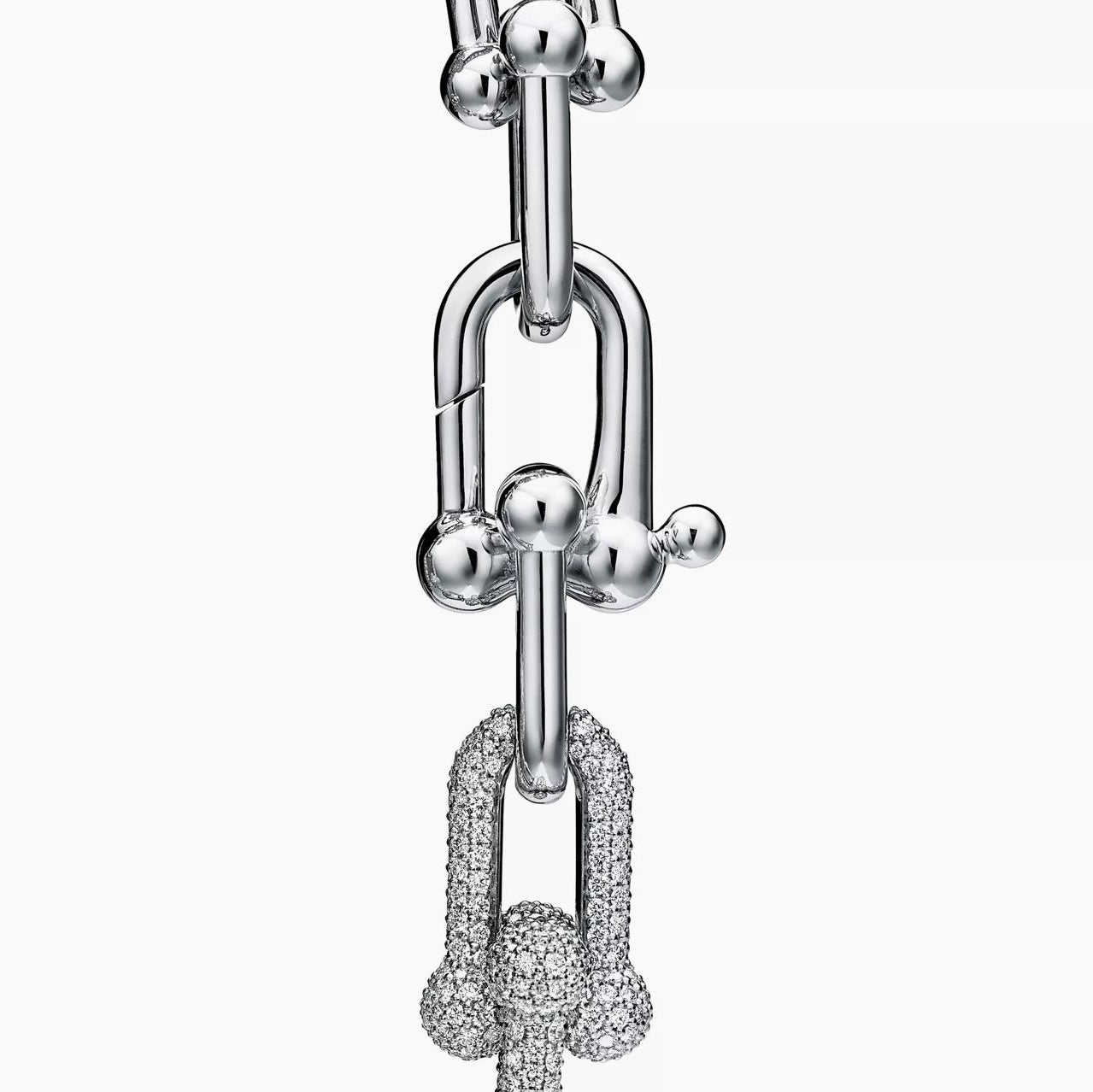 Silver bracelet with a diamond-knot charm on a white background