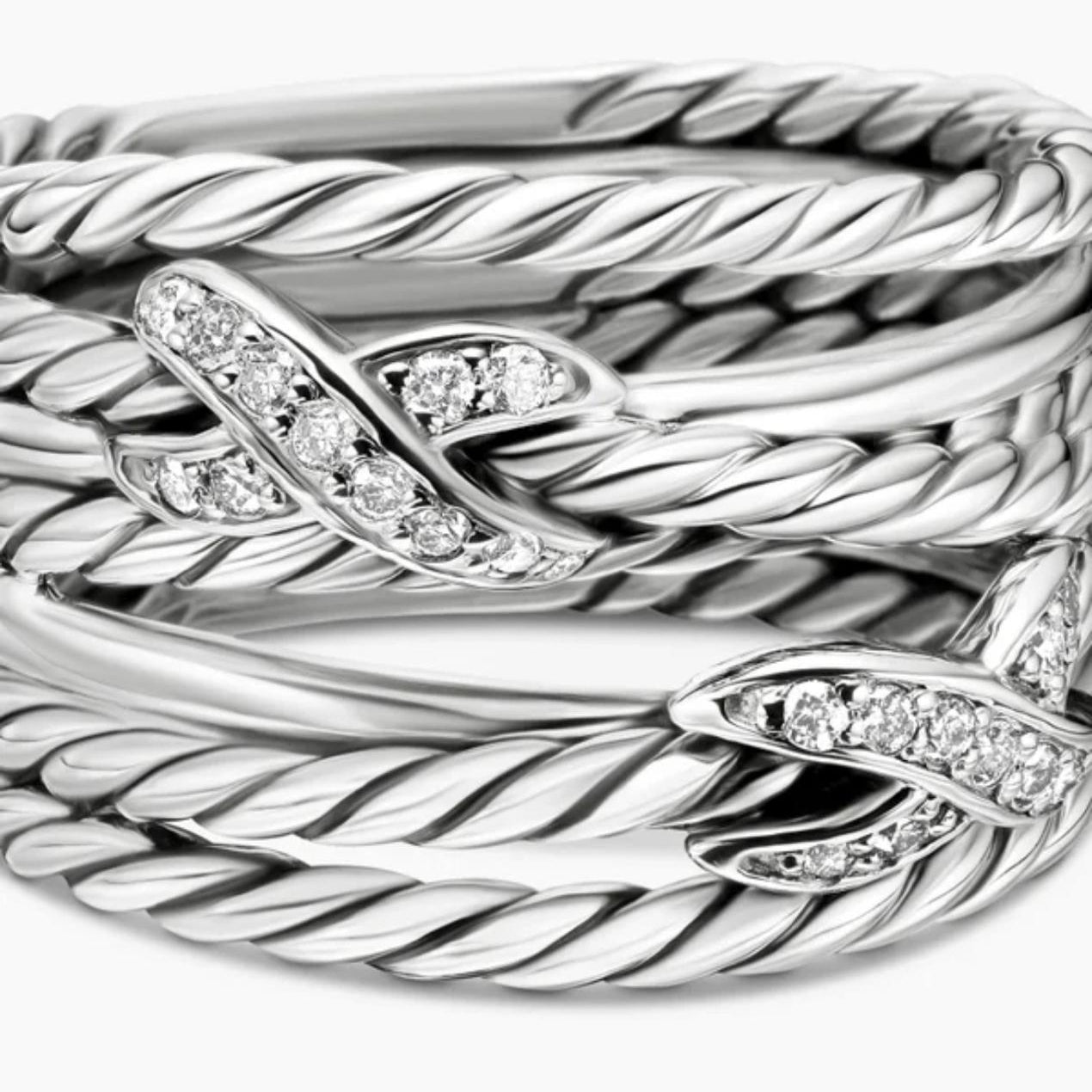 Silver bracelet with braided design and diamond accents on a white background