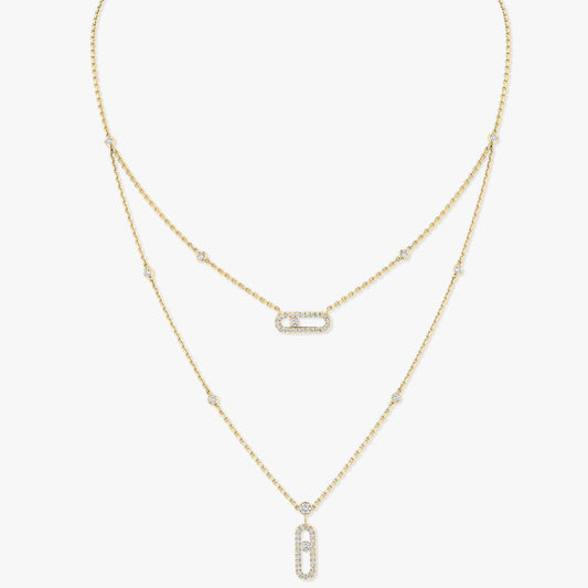 Gold necklace with diamond pendants on a white background