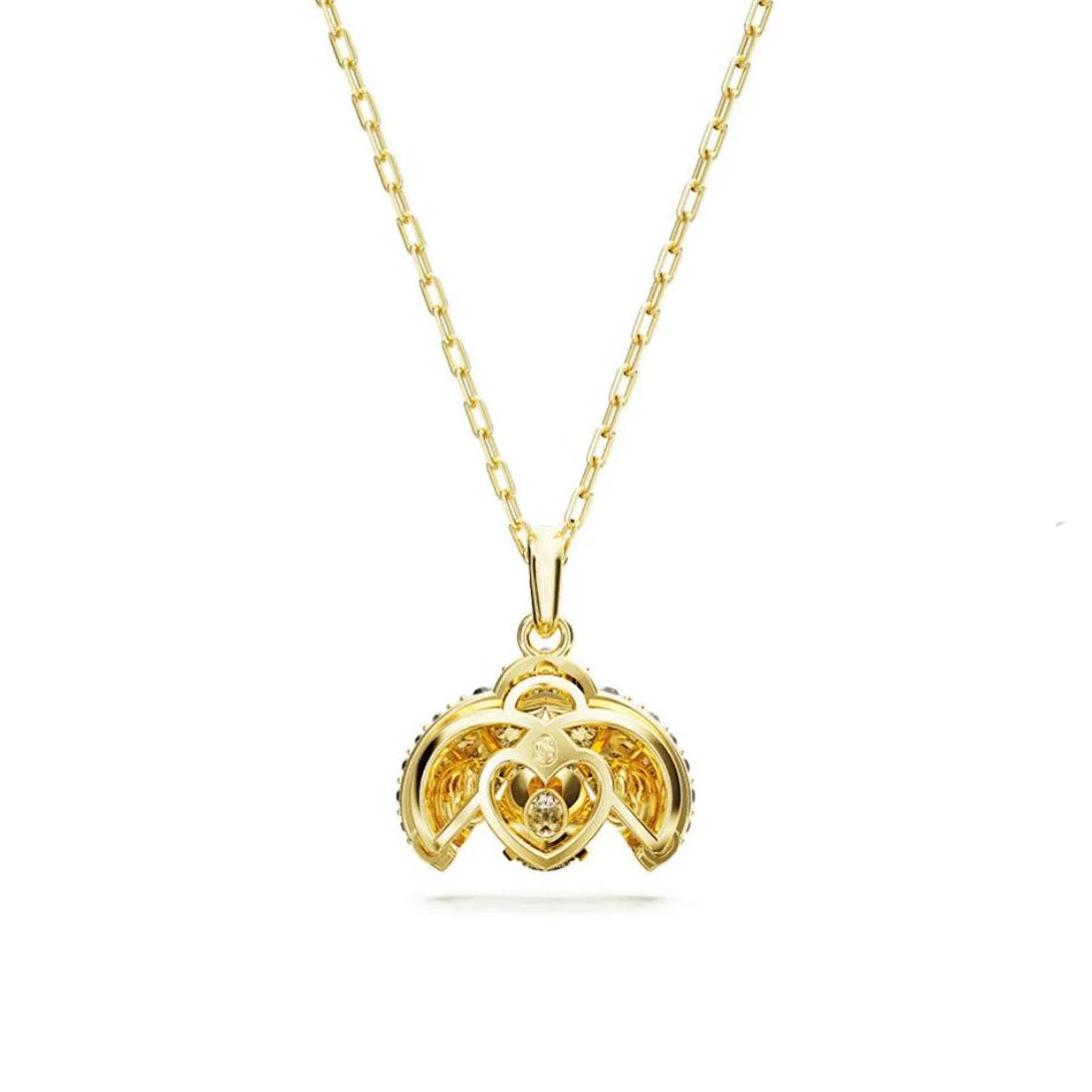 Gold necklace with a heart-shaped pendant on a white background