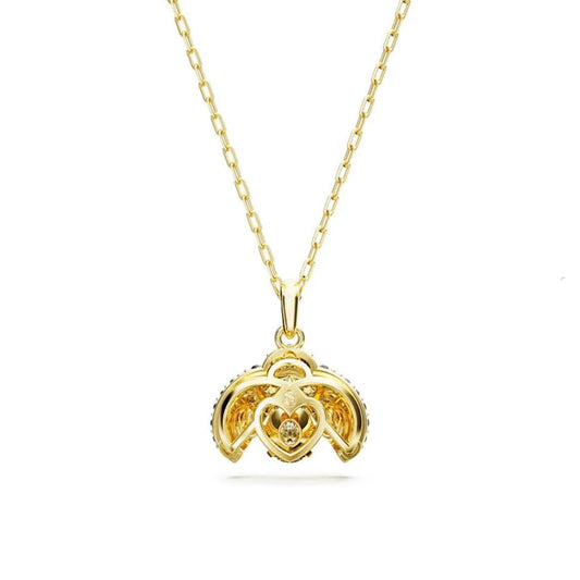 Gold necklace with a heart-shaped pendant on a white background