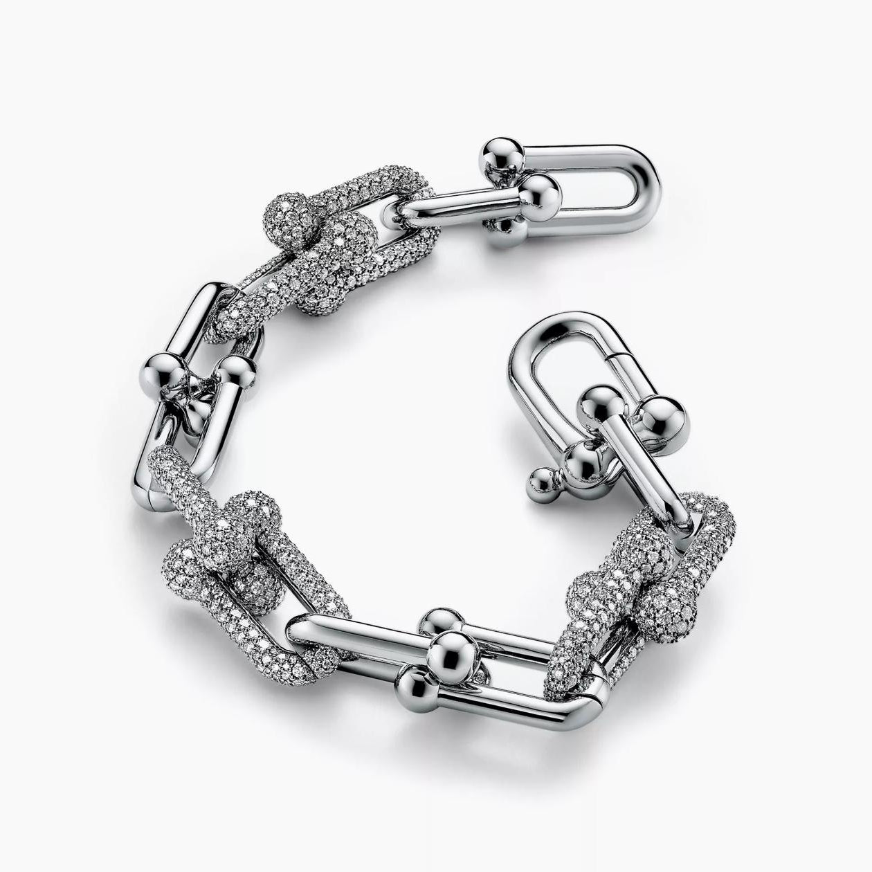 Silver bracelet with interlocking links on a white background